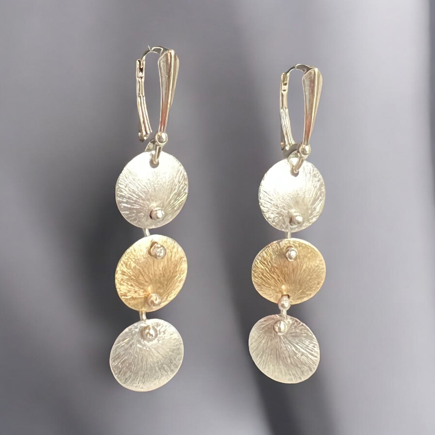 Kinetic 3 tier circle design earrings in silver and gold, classic with a twist