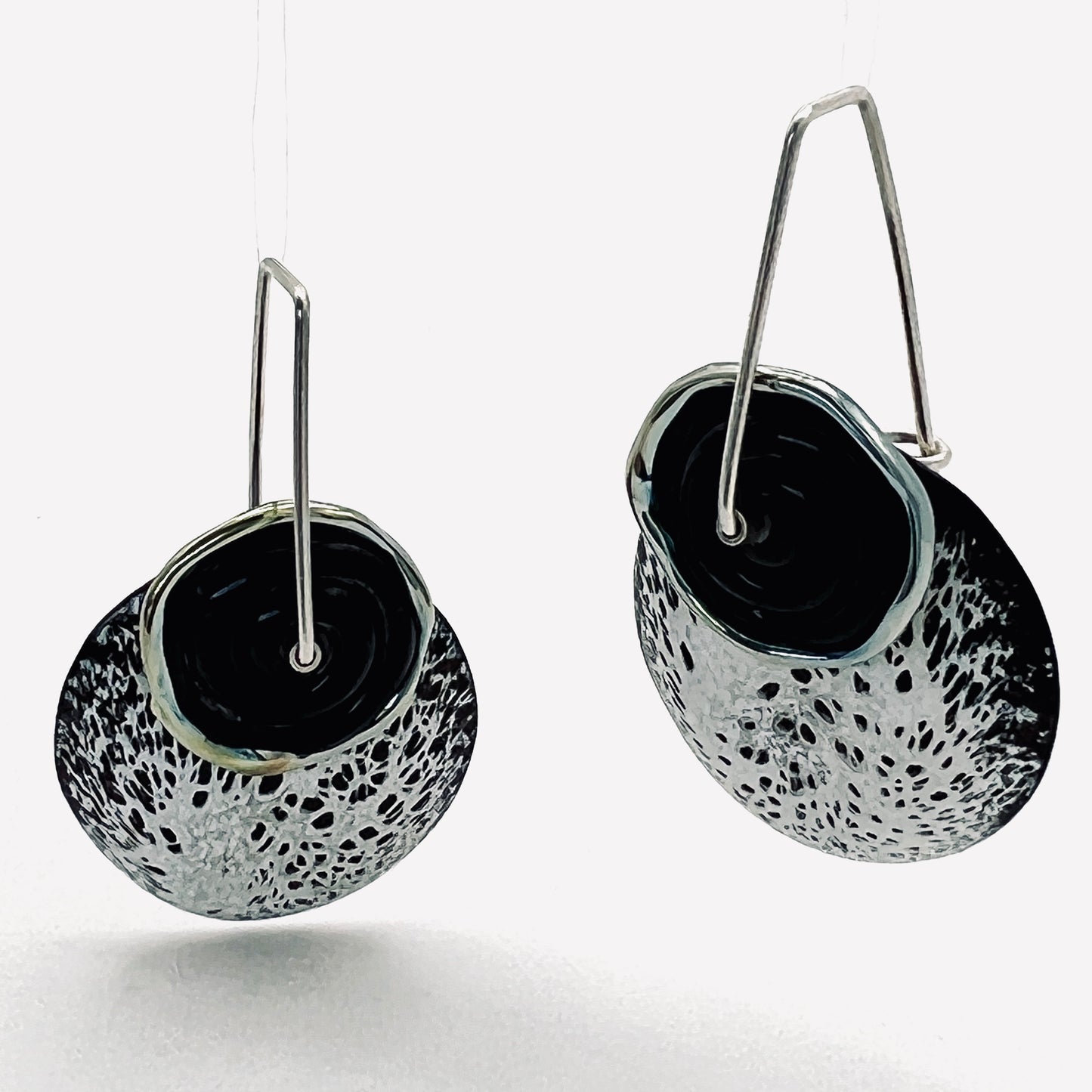 One of a kind Black and white speckled design enamel earrings with black lamp work glass bead, sterling silver ear wires.