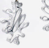 Modern flower earrings. Contemporary and lightweight statement earrings in silver.  Unique and fun to wear!