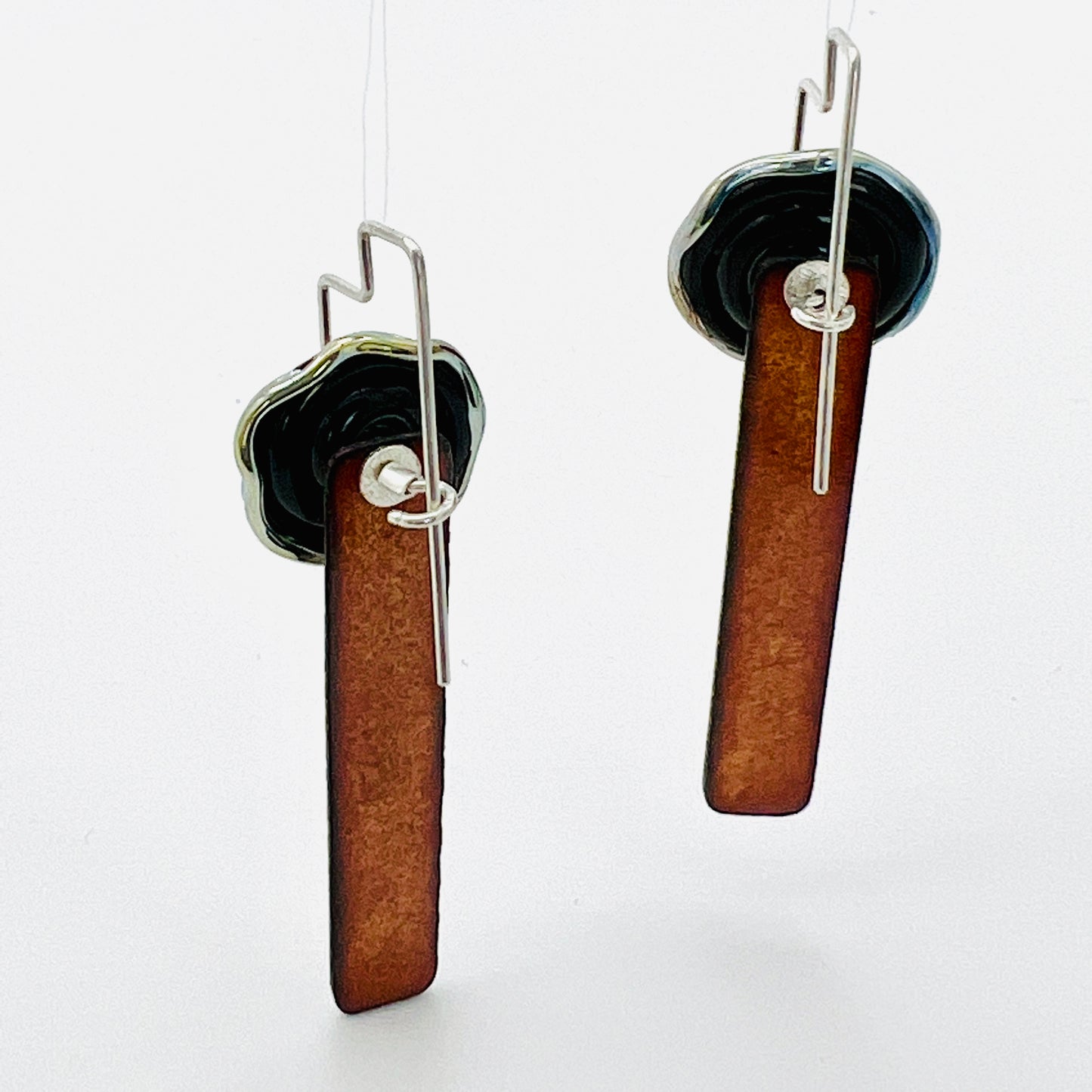 Black and gold handmade and textured one of a kind dangle earrings with sterling silver ear wires. Beautifully finished front and back!