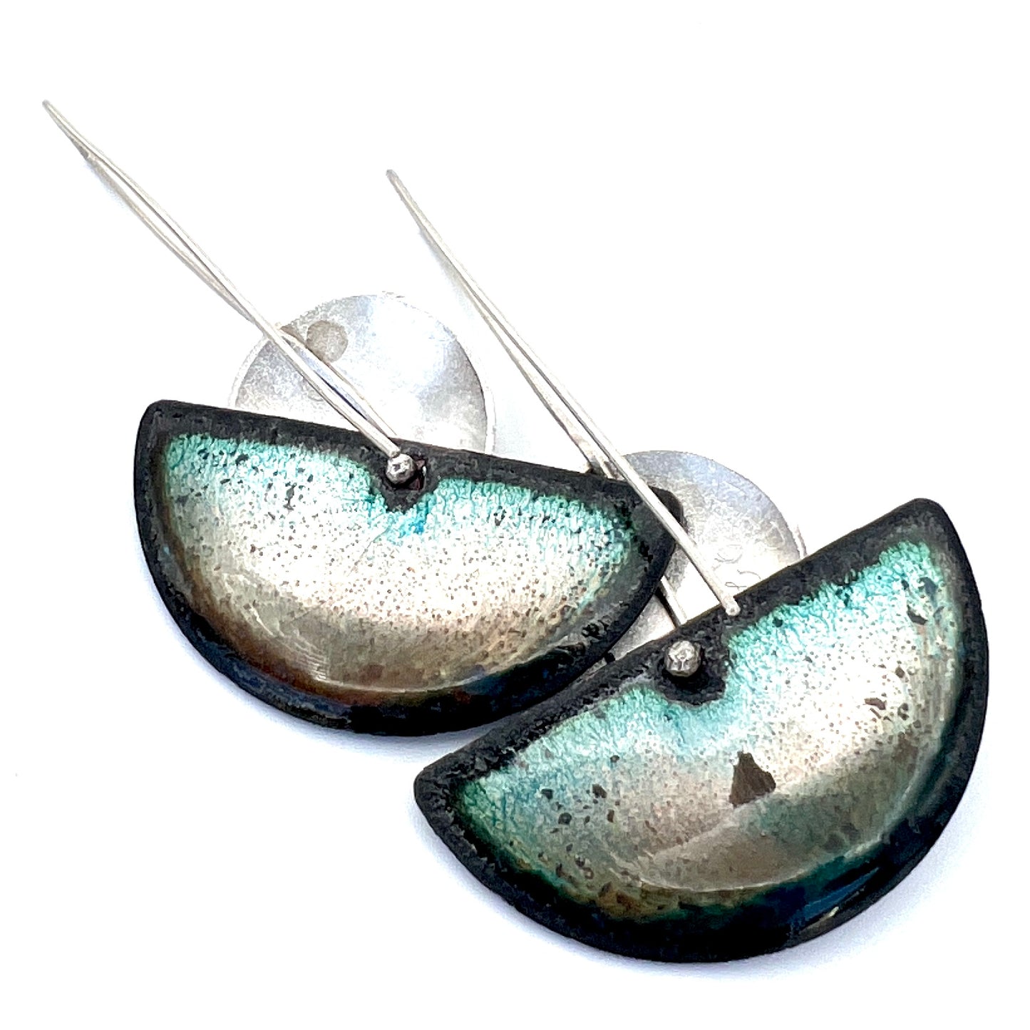 The enamel on the back of these earrings is a gorgeous palette of iridescent colors to include golden shades and as well as greens, framed in with a black edge.