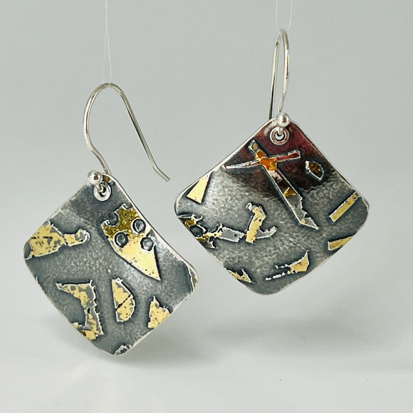 Deeply oxidized sterling silver and 24K gold combine in these square shape dangle earrings hung on diagonal