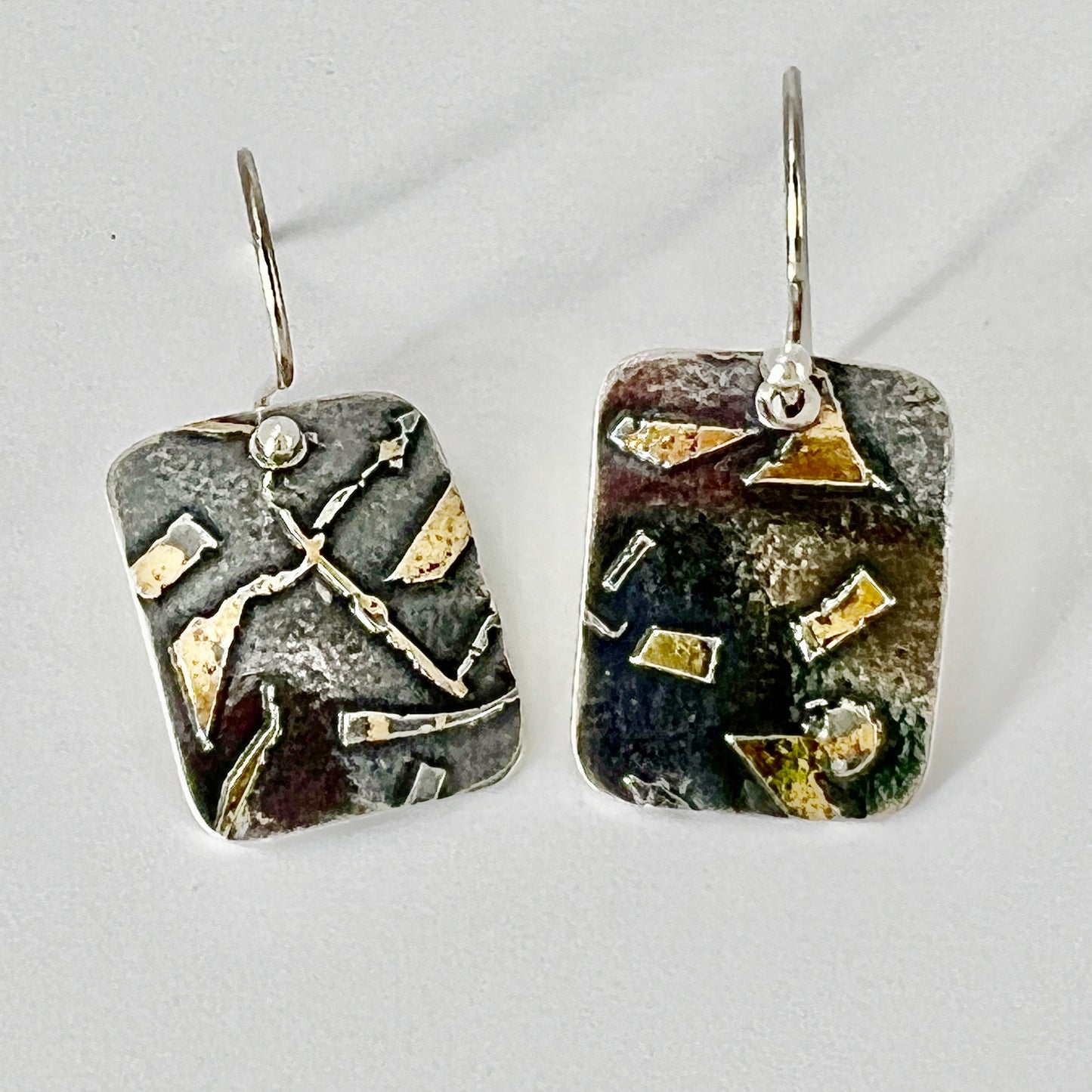 Deeply oxidized sterling silver and 24K gold combine in these small rectangle shape dangle earrings...modern, one of a kind.