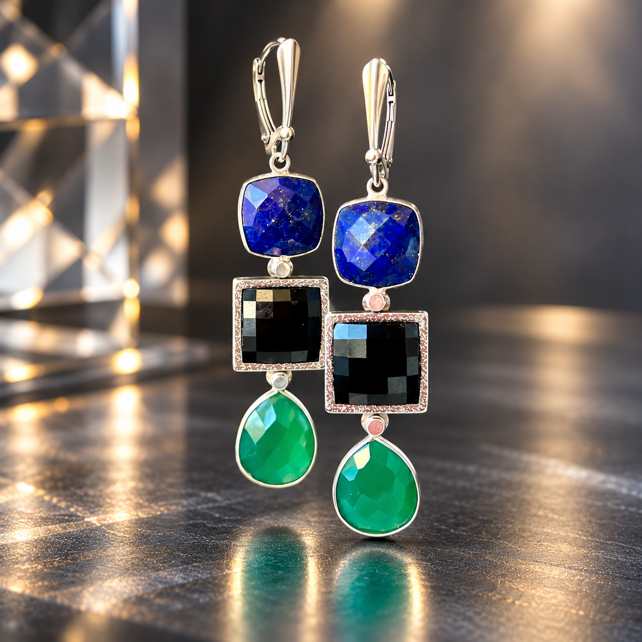 Aurora Spectrum earrings with square blue lapis stones, black faceted Swarovski crystals in hand-engraved sterling silver bezels, green faceted onyx drops, and sterling silver leverback ear wires.