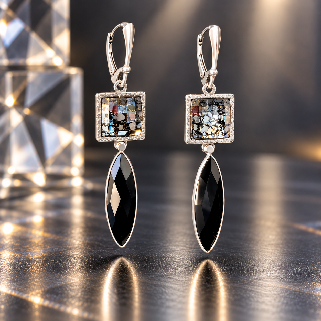 Aurora Shadow kinetic earrings featuring square Swarovski crystals with black-threaded faceting in hand-engraved sterling silver bezels, elongated faceted black onyx marquise drops, and sterling silver leverback ear wires.