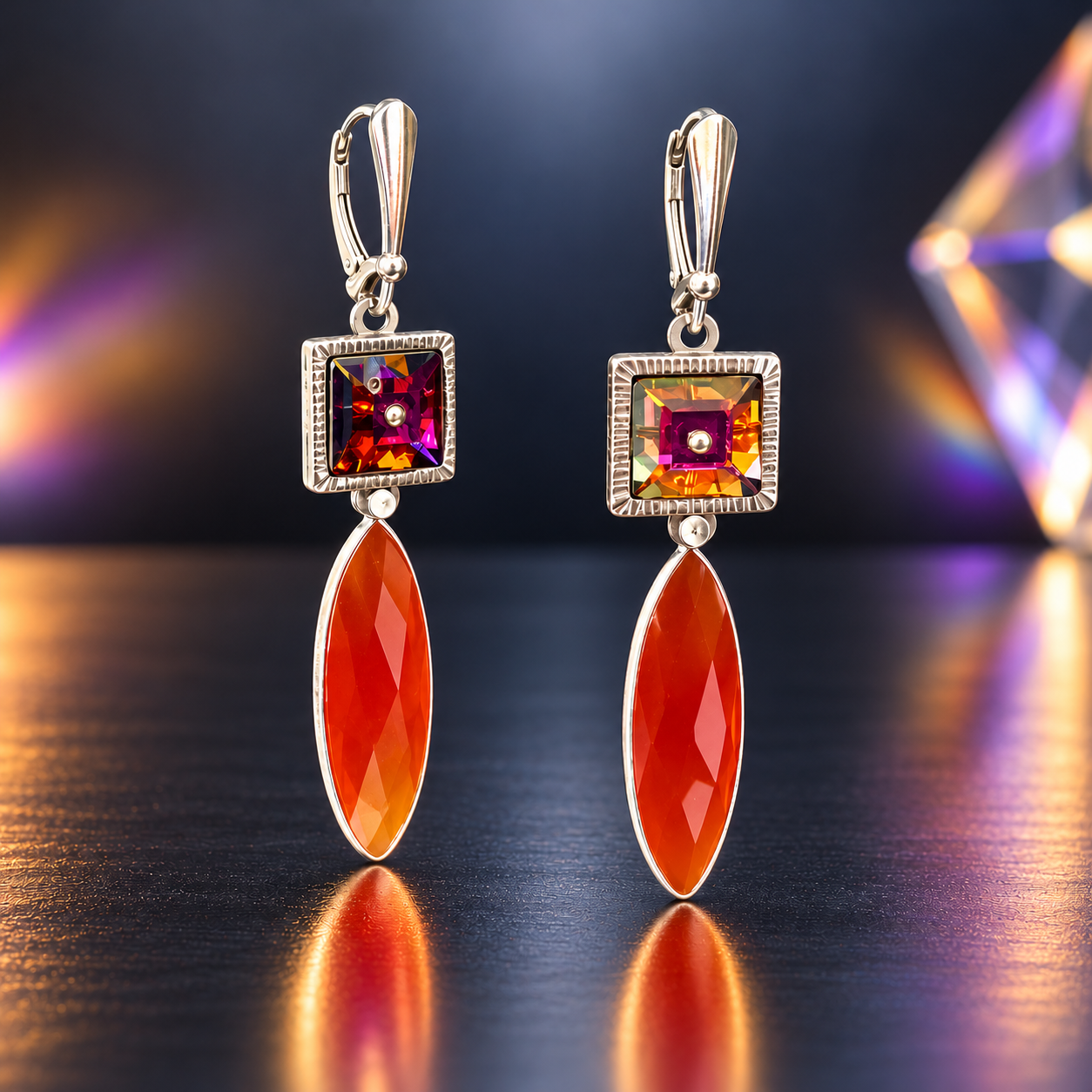 Handmade dangle earrings with vintage multicolor Swarovski crystals in hand-engraved stainless steel bezels, elongated faceted red onyx drops, and sterling silver leverback ear wires.

