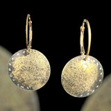 "Edgy elegance"....modern minimalist steel, 22K gold circle dangles