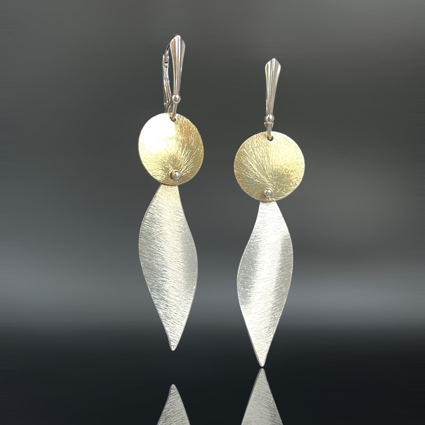 Bold, lightweight leaf and circle geometric design gold and silver dangles