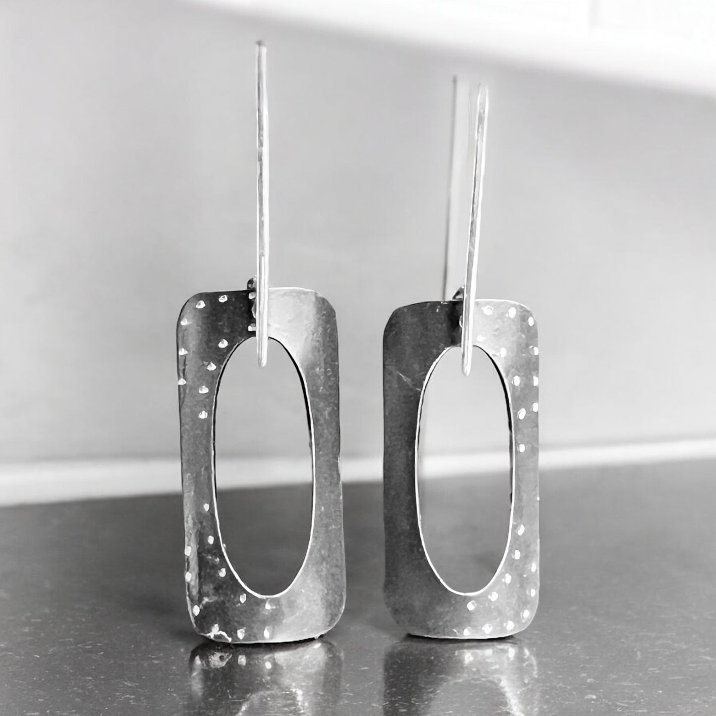 Geometric and bold in black, contemporary steel, sterling silver dangles