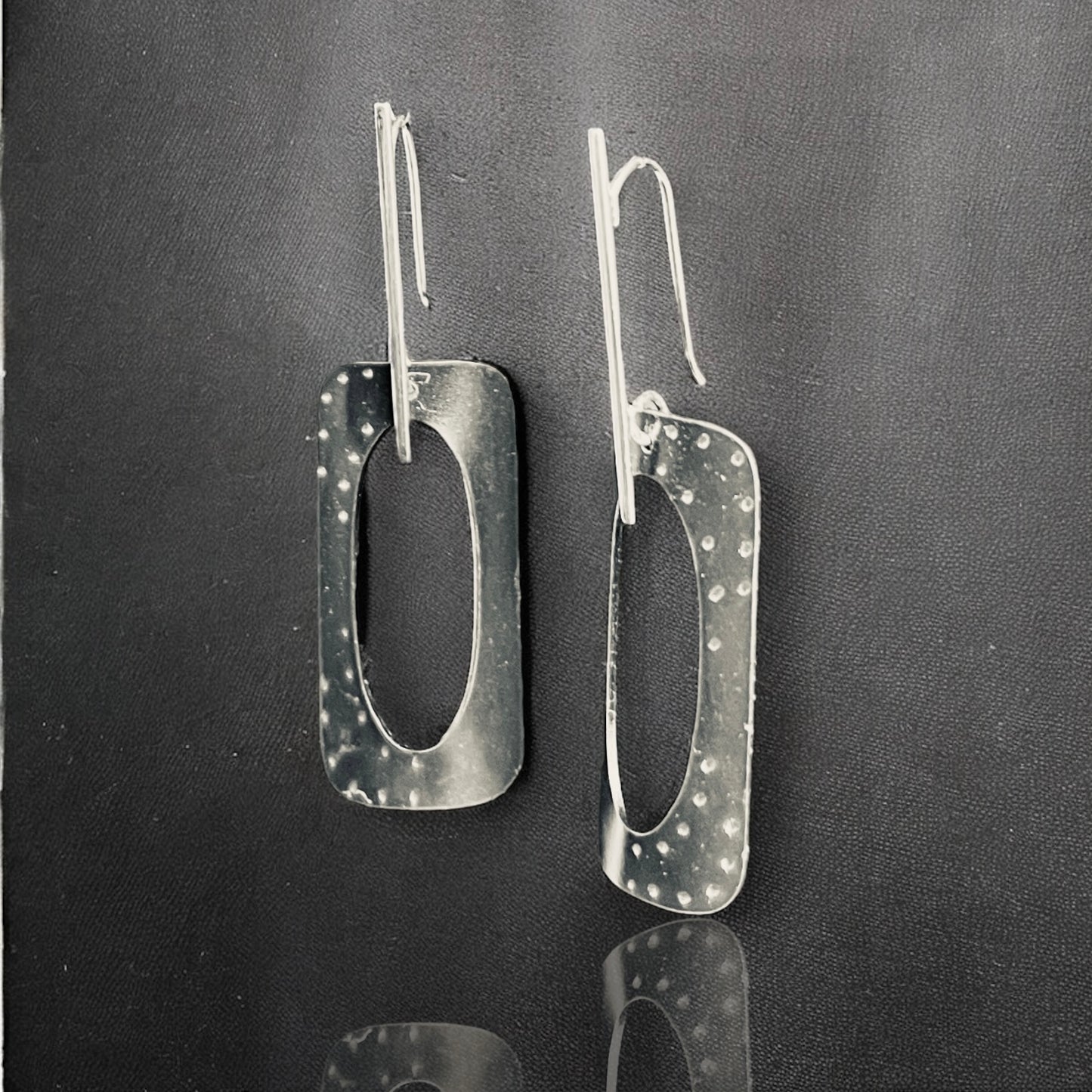 Geometric and bold in black, contemporary steel, sterling silver dangles