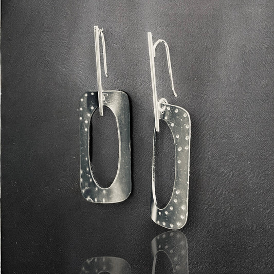 Geometric and bold in black, contemporary steel, sterling silver dangles