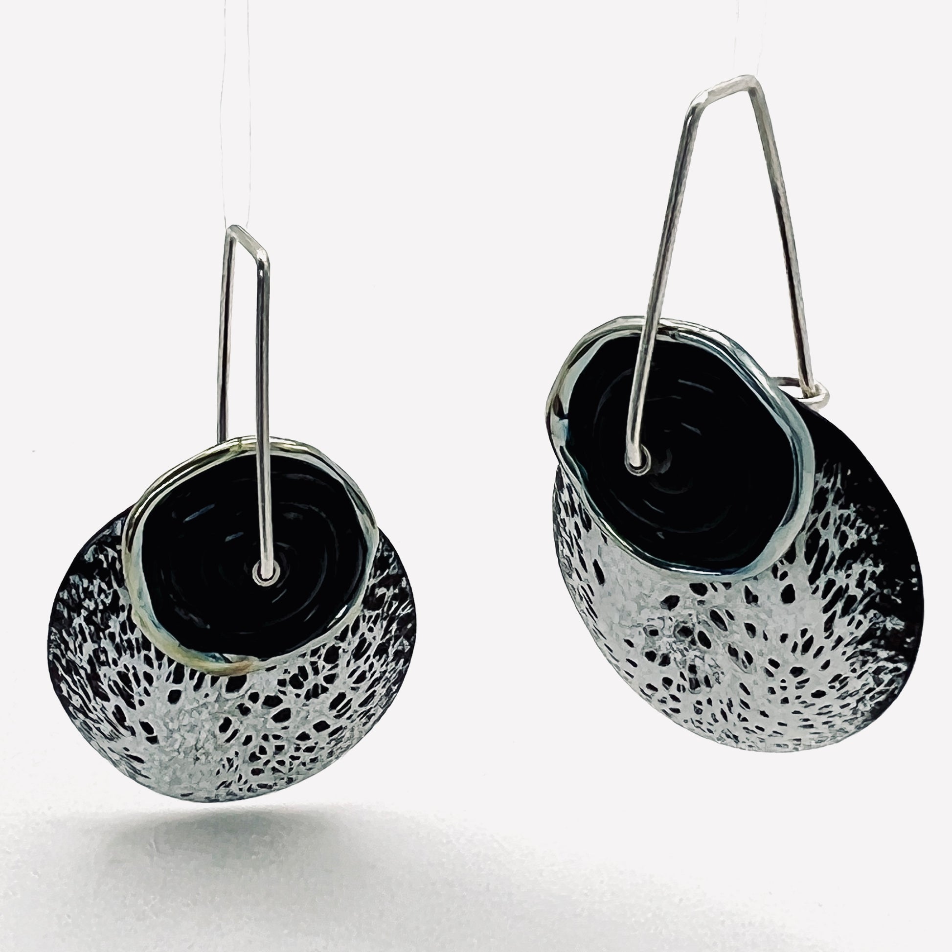 One of a kind Black and white speckled design enamel earrings with black lamp work glass bead, sterling silver ear wires.