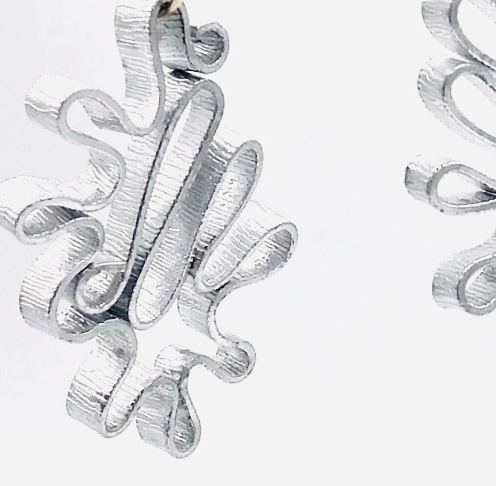 Modern flower earrings. Contemporary and lightweight statement earrings in silver.  Unique and fun to wear!