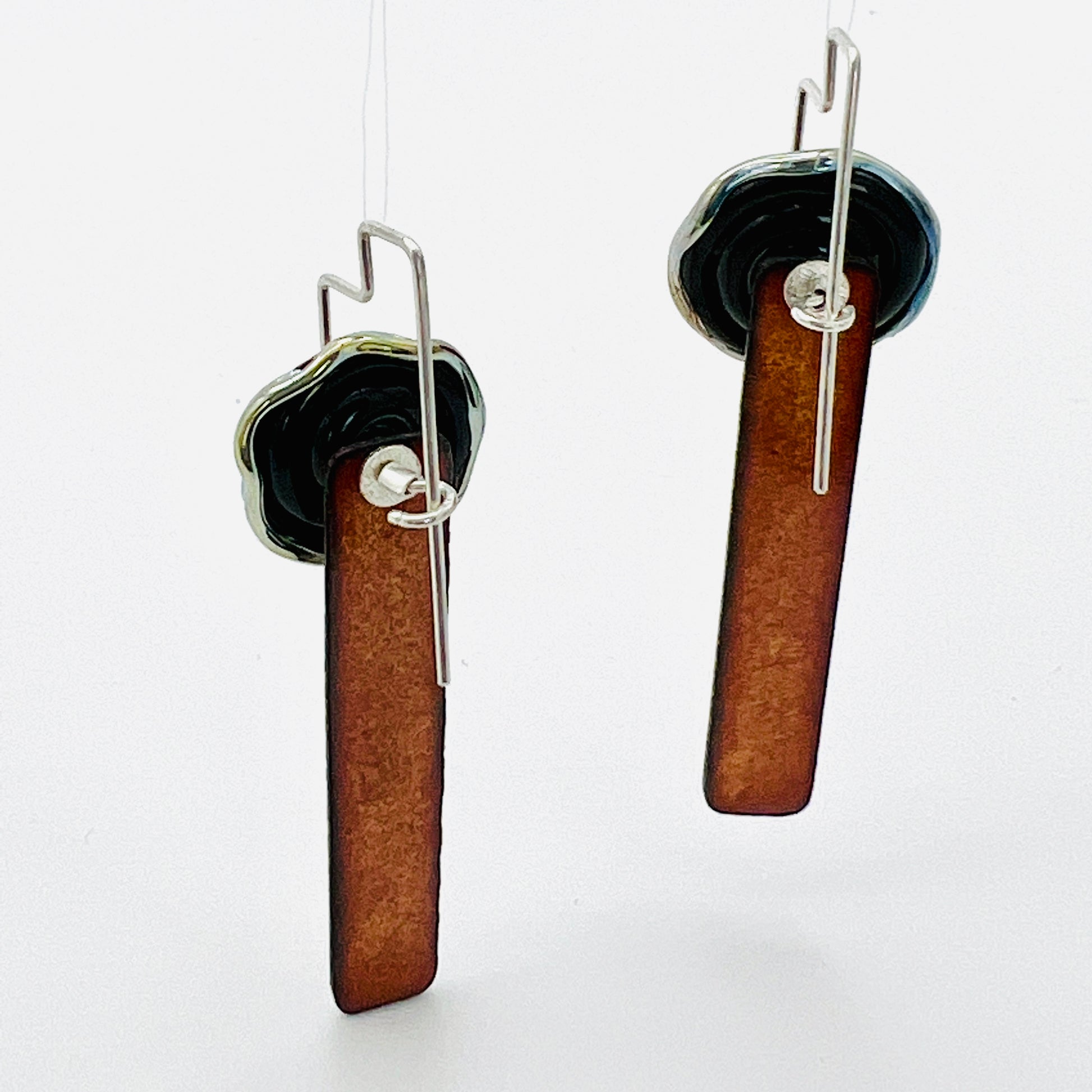 Black and gold handmade and textured one of a kind dangle earrings with sterling silver ear wires.  Beautifully finished front and back!
