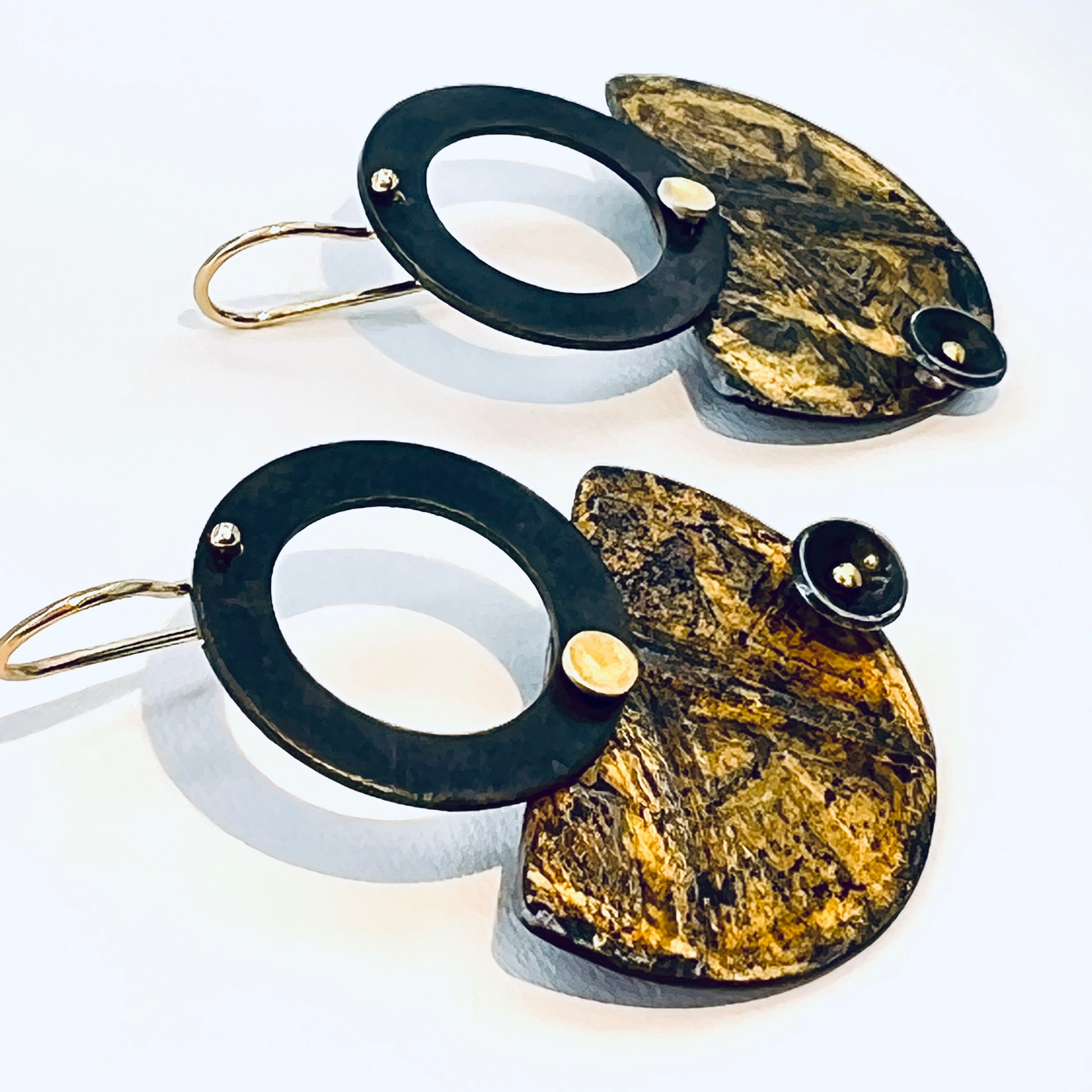 Black and gold steel earrings in geometric shapes