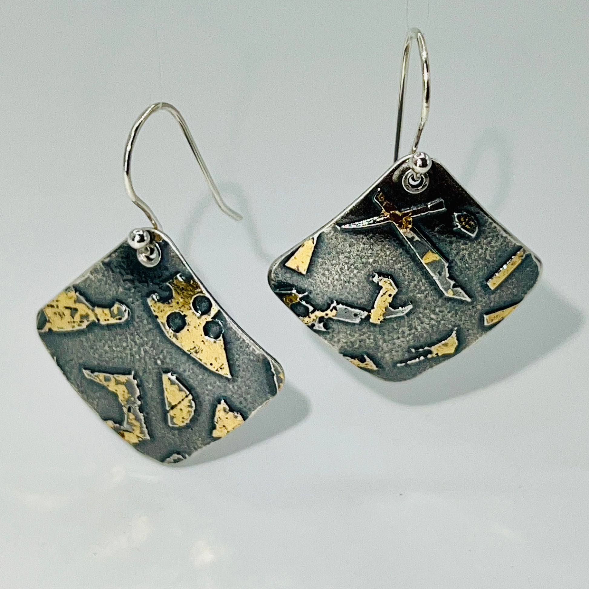 Deeply oxidized sterling silver and 24K gold combine in these square shape dangle earrings hung on diagonal