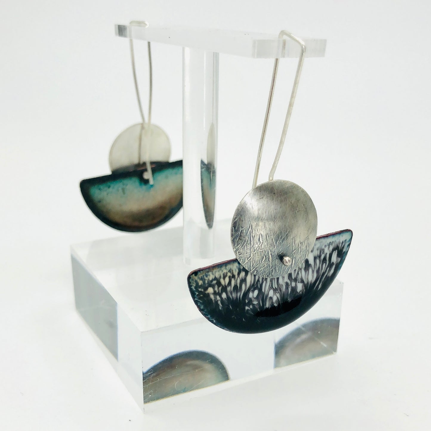 The design of these earrings is lovely with a half moon shape dangling from long and graceful ear wires. The length of the wires extends down the back of the design as well to insure a well balanced design as well as a secure one.
