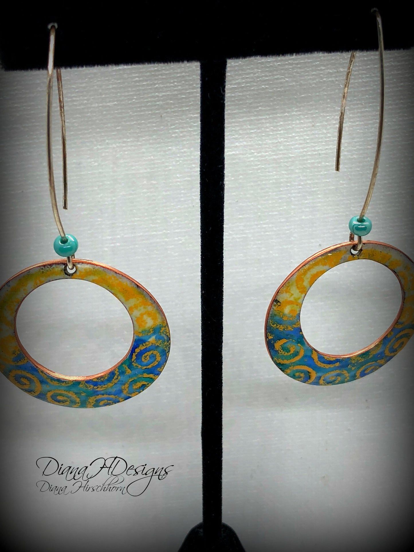 Geometric open hoop earrings are retro as well as modern.  Yellow, blue, green vitreous enamel.