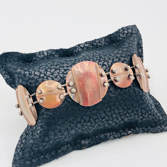 Interconnecting circles create this beautiful copper & sterling bracelet.  Modern, with an architectural vibe.