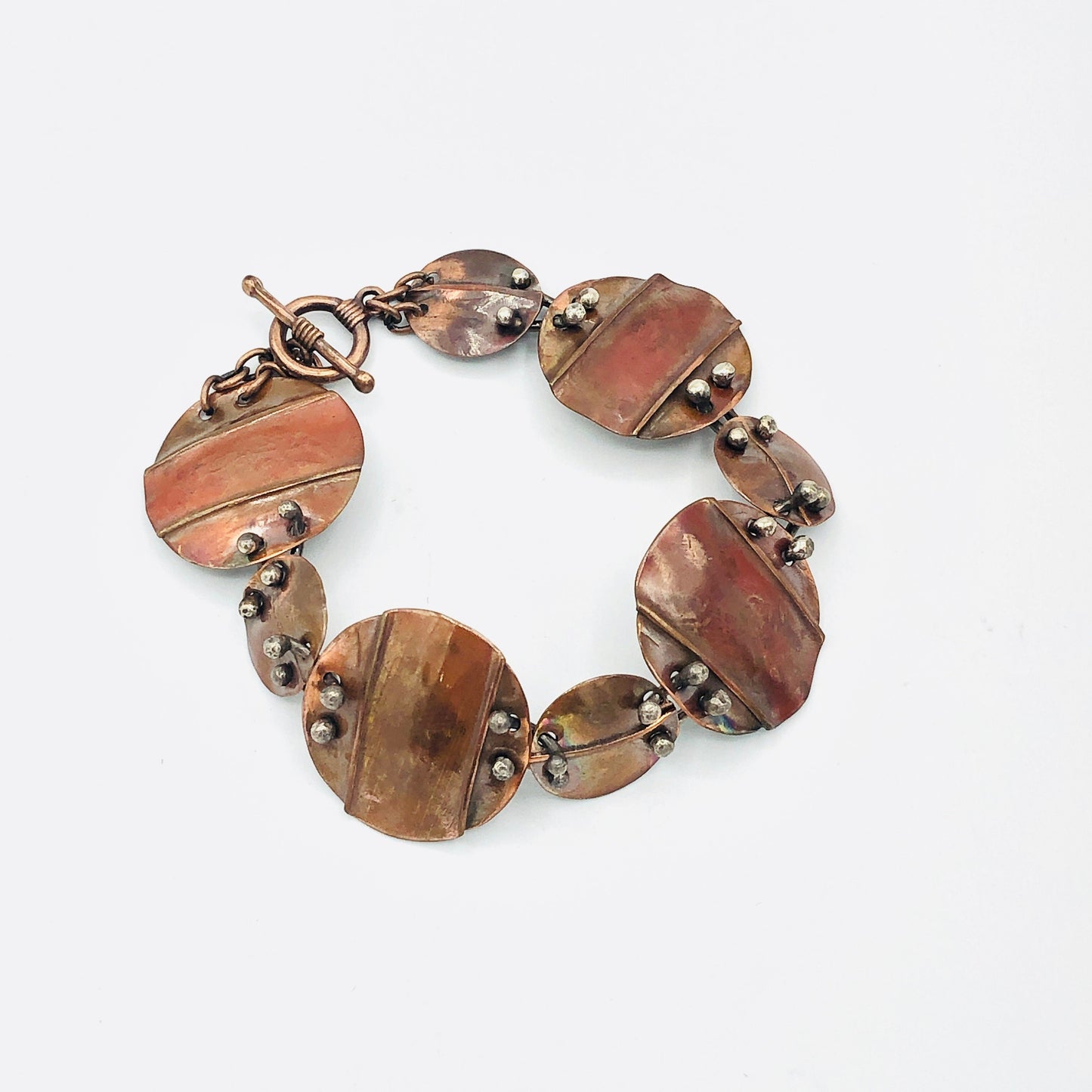 Interconnecting circles create this beautiful copper & sterling bracelet.  Modern, with an architectural vibe.