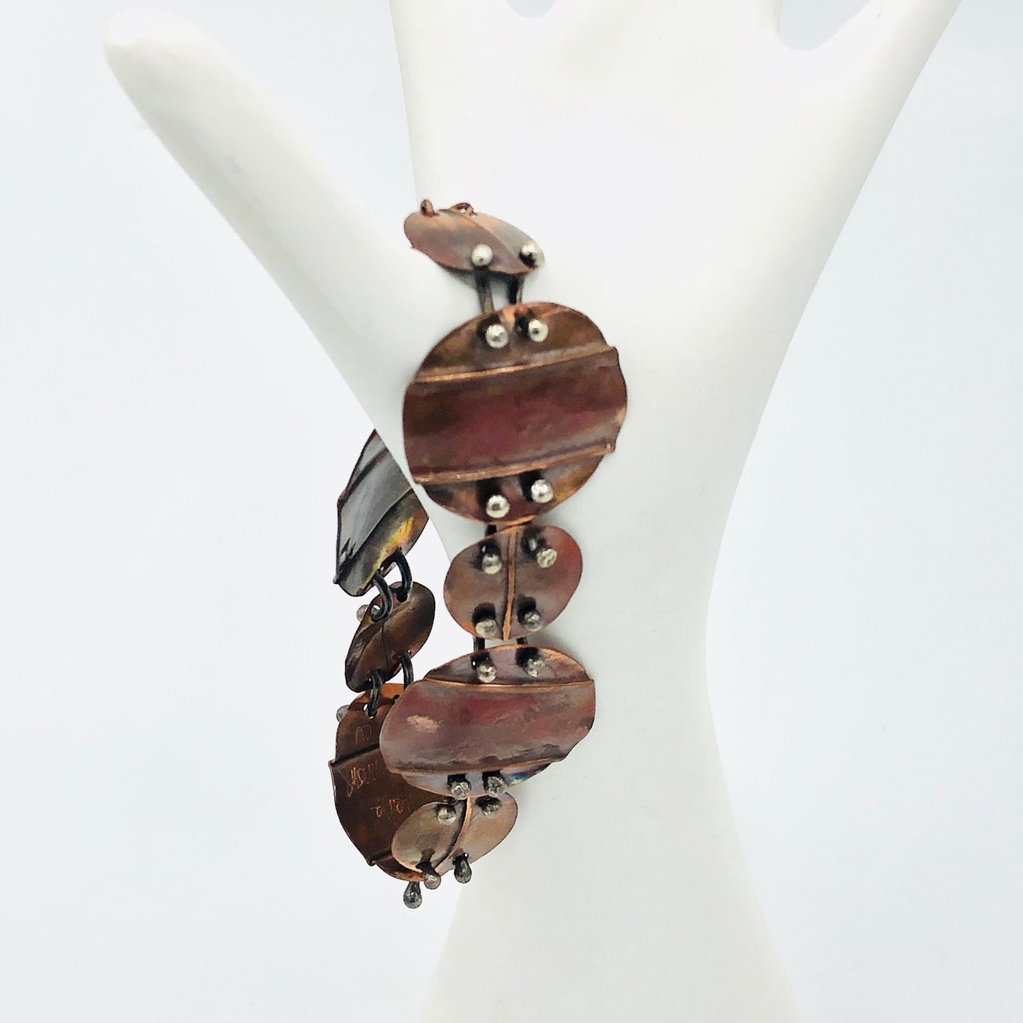 Interconnecting circles create this beautiful copper & sterling bracelet.  Modern, with an architectural vibe.
