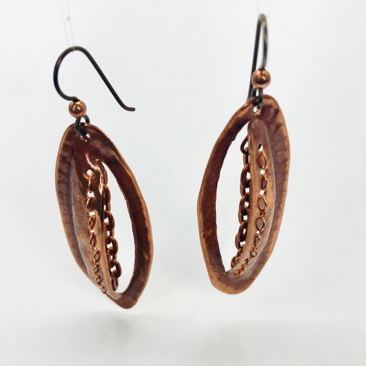 Incredibly unique copper earrings boast stitched detailing with chain.  Niobium ear wires