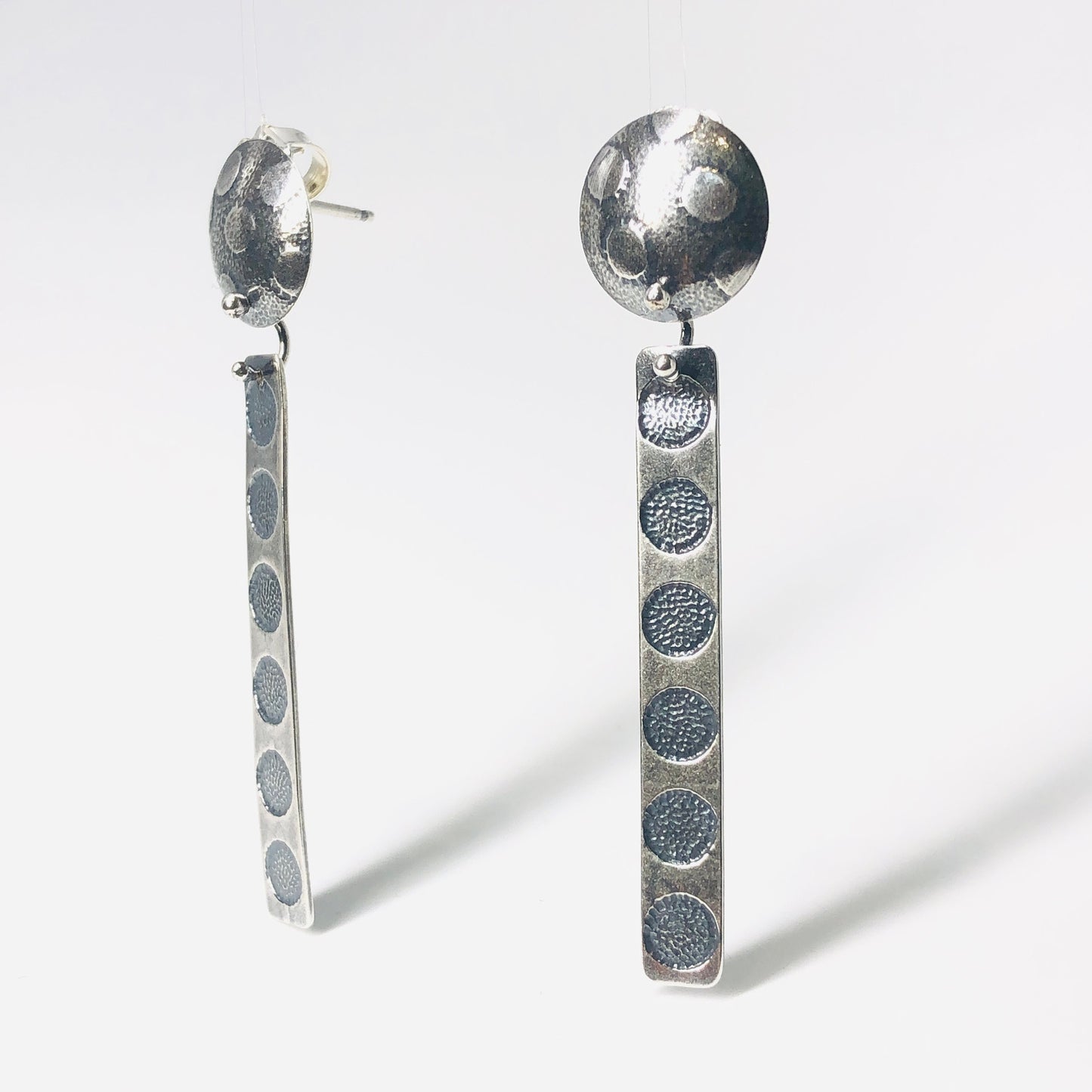 Polka dot long dangle post earrings.